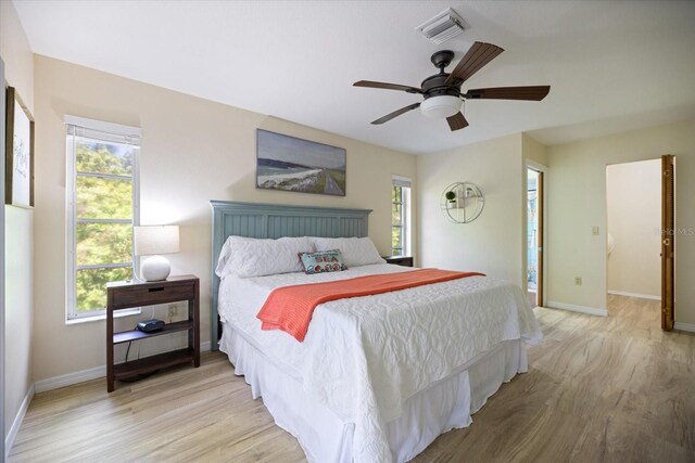 9277 Saint Catherine Ave, Englewood, FL 34224 - bedroom with light wood finished floors, baseboards, and a ceiling fan
