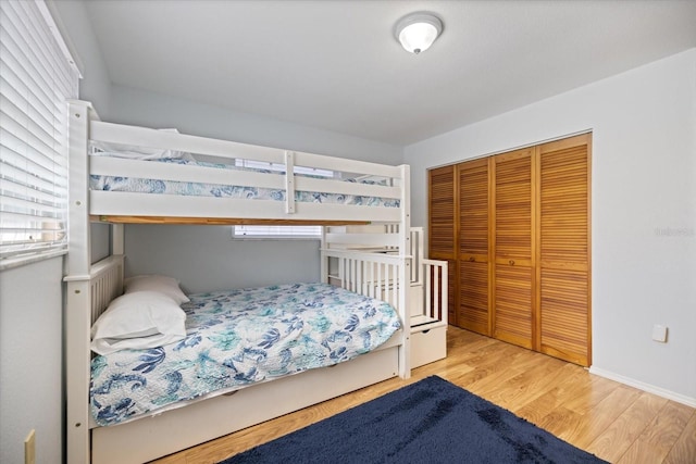 9277 Saint Catherine Ave, Englewood, FL 34224 - bedroom with wood finished floors, a closet, and multiple windows