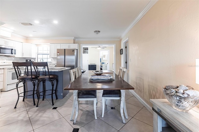 306 E Penn Rd, Lehigh Acres, FL 33936 - dining room featuring ornamental molding, a ceiling fan, and light tile patterned flooring