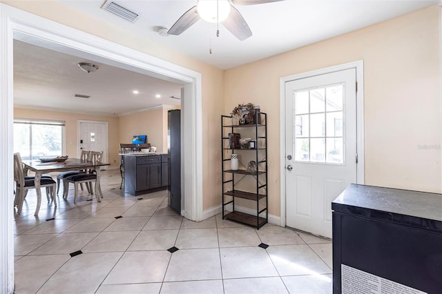 306 E Penn Rd, Lehigh Acres, FL 33936 - entryway featuring a ceiling fan, baseboards, ornamental molding, and light tile patterned floors