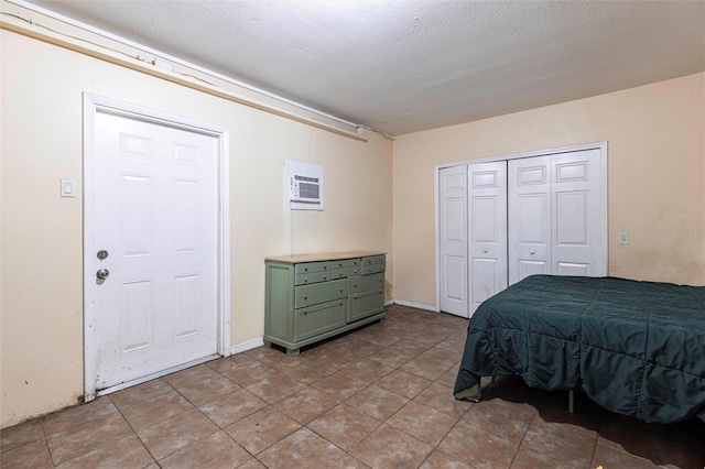 306 E Penn Rd, Lehigh Acres, FL 33936 - bedroom featuring a wall mounted AC, light tile patterned floors, and a closet