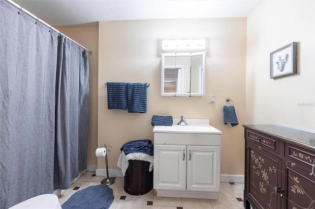 306 E Penn Rd, Lehigh Acres, FL 33936 - bathroom with vanity, tile patterned floors, baseboards, toilet, and a shower with shower curtain