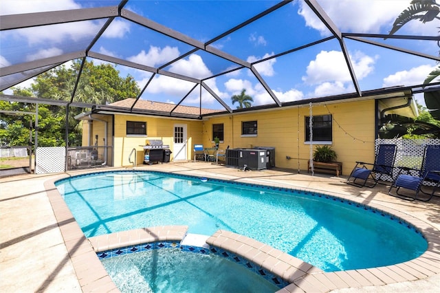 306 E Penn Rd, Lehigh Acres, FL 33936 - view of swimming pool featuring a patio area, area for grilling, central air condition unit, a pool with connected hot tub, and a lanai