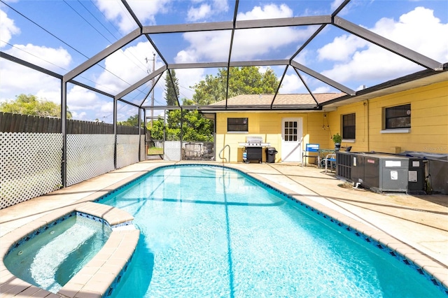 306 E Penn Rd, Lehigh Acres, FL 33936 - view of swimming pool featuring a patio area, a pool with connected hot tub, and glass enclosure