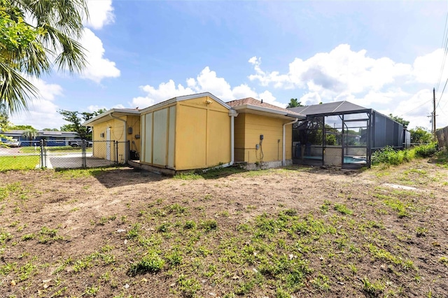 306 E Penn Rd, Lehigh Acres, FL 33936 - rear view of property featuring a gate and glass enclosure
