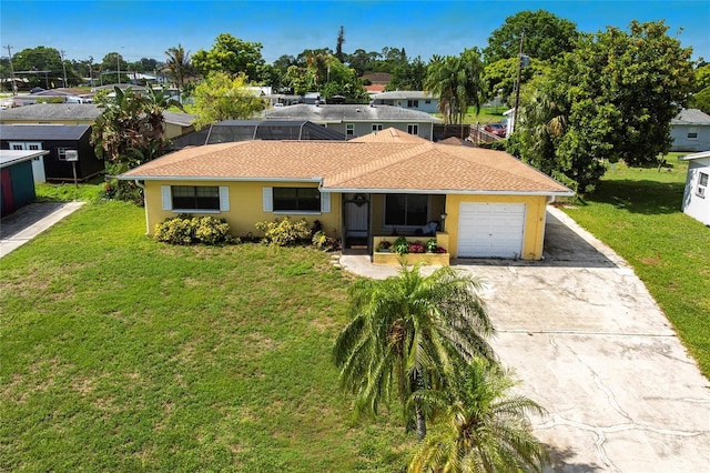 306 E Penn Rd, Lehigh Acres, FL 33936 - view of front of property featuring concrete driveway, a garage, and a front lawn