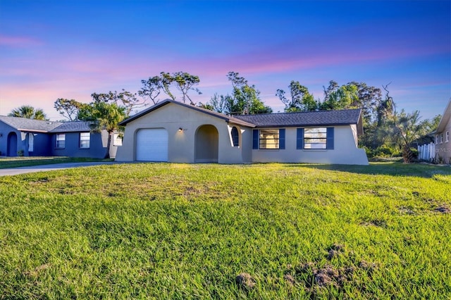 1032 Elaine St, Venice, FL 34285 - ranch-style house featuring driveway, a front lawn, a garage, and stucco siding