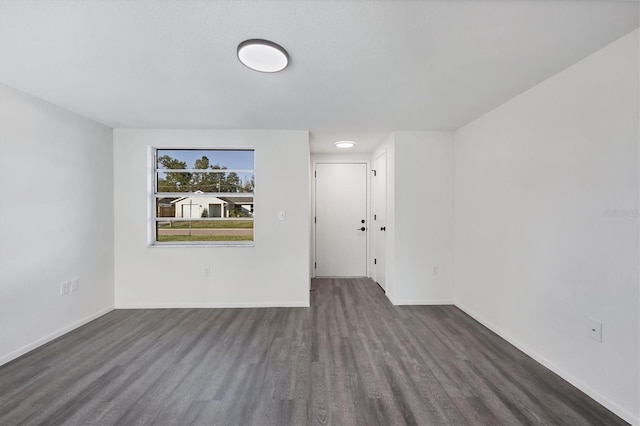 1032 Elaine St, Venice, FL 34285 - spare room featuring dark wood-type flooring and baseboards