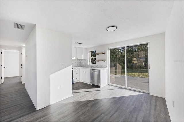 1032 Elaine St, Venice, FL 34285 - kitchen featuring stainless steel dishwasher, white cabinets, dark wood-style floors, light countertops, and decorative backsplash
