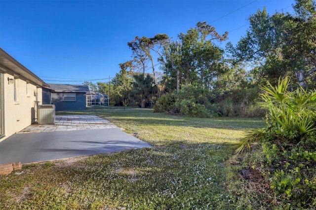 1032 Elaine St, Venice, FL 34285 - view of grassy yard featuring a patio area and central AC