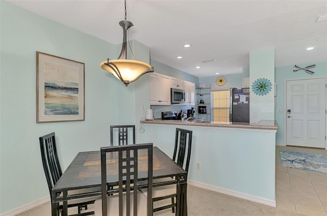 8409 Placida Rd Unit 206, Placida, FL 33946 - dining room with baseboards, recessed lighting, and light colored carpet