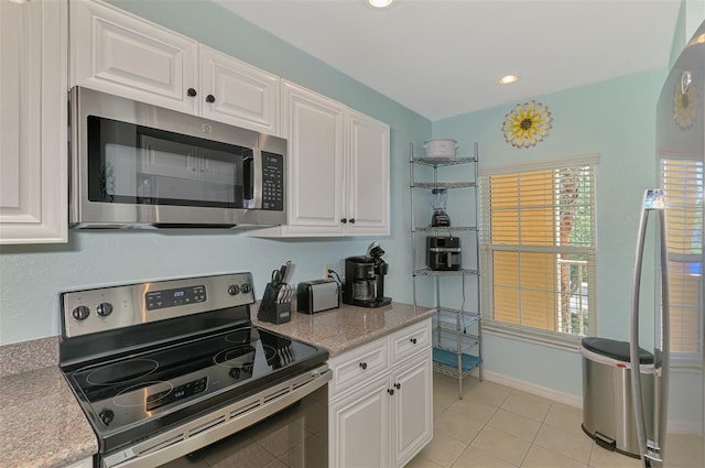 8409 Placida Rd Unit 206, Placida, FL 33946 - kitchen featuring stainless steel appliances, white cabinets, light tile patterned floors, recessed lighting, and baseboards