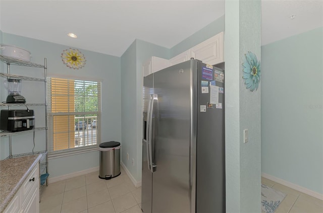 8409 Placida Rd Unit 206, Placida, FL 33946 - kitchen featuring stainless steel refrigerator with ice dispenser, light tile patterned flooring, white cabinetry, baseboards, and recessed lighting