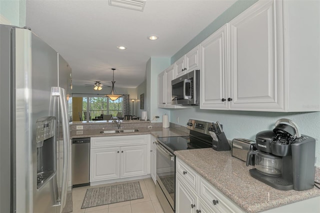 8409 Placida Rd Unit 206, Placida, FL 33946 - kitchen with appliances with stainless steel finishes, a sink, white cabinets, ceiling fan, and light tile patterned floors