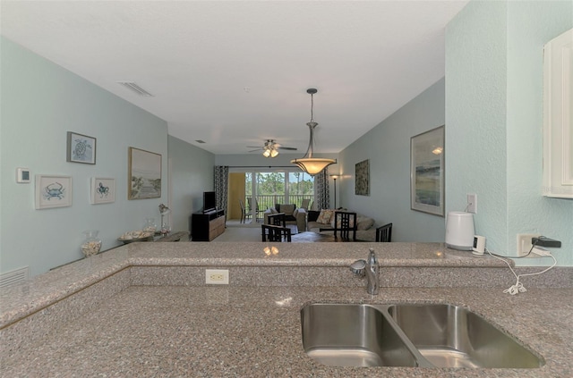 8409 Placida Rd Unit 206, Placida, FL 33946 - kitchen featuring a sink, a ceiling fan, pendant lighting, and stone counters