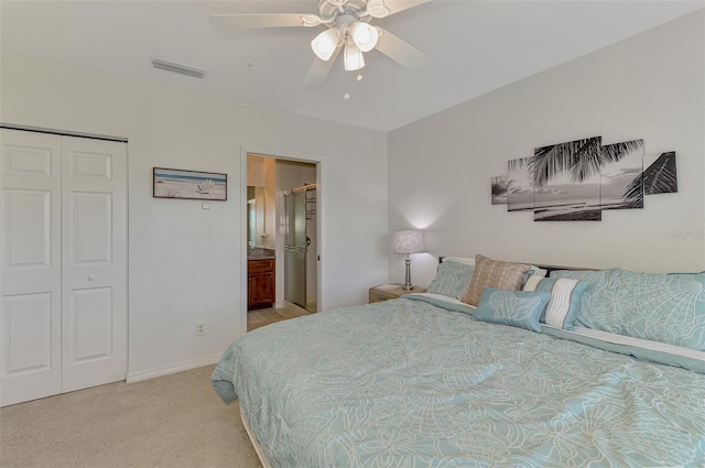 8409 Placida Rd Unit 206, Placida, FL 33946 - bedroom featuring light carpet, a closet, ceiling fan, baseboards, and ensuite bathroom