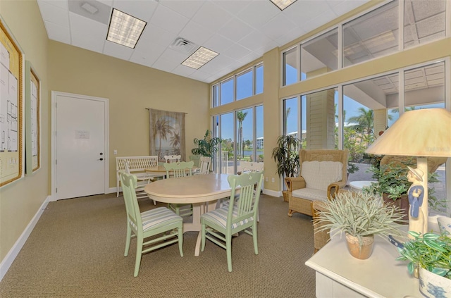 8409 Placida Rd Unit 206, Placida, FL 33946 - carpeted dining room featuring baseboards and a towering ceiling