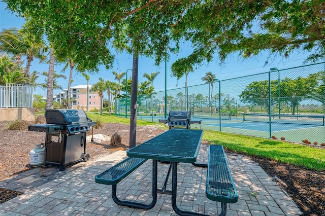 8409 Placida Rd Unit 206, Placida, FL 33946 - view of patio with area for grilling and a tennis court