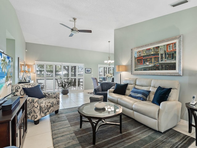 114 Southampton Pl N Unit 237, Venice, FL 34293 - living room with tile patterned flooring, a ceiling fan, a chandelier, baseboards, and lofted ceiling