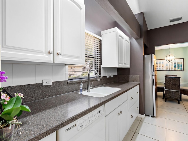 114 Southampton Pl N Unit 237, Venice, FL 34293 - kitchen featuring dishwasher, freestanding refrigerator, a sink, dark countertops, and light tile patterned floors