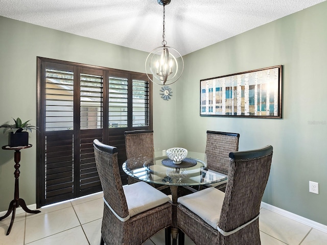114 Southampton Pl N Unit 237, Venice, FL 34293 - dining area featuring a chandelier, tile patterned floors, a textured ceiling, and baseboards