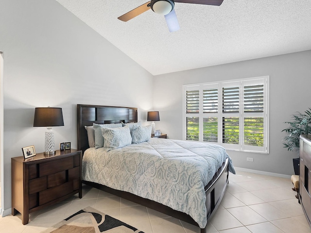 114 Southampton Pl N Unit 237, Venice, FL 34293 - bedroom featuring a textured ceiling, light tile patterned flooring, vaulted ceiling, ceiling fan, and baseboards