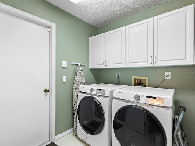 114 Southampton Pl N Unit 237, Venice, FL 34293 - washroom with cabinet space, independent washer and dryer, a textured ceiling, and baseboards