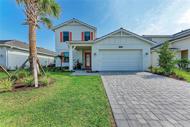 12816 Morning Mist Pl, Venice, FL 34293 - traditional home with decorative driveway, an attached garage, a front lawn, and board and batten siding