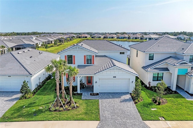 12816 Morning Mist Pl, Venice, FL 34293 - view of front facade featuring a residential view, an attached garage, decorative driveway, and a front lawn