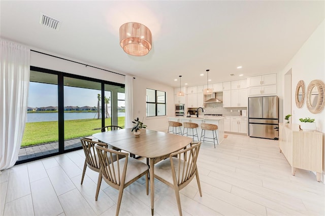12816 Morning Mist Pl, Venice, FL 34293 - dining space featuring a water view and recessed lighting