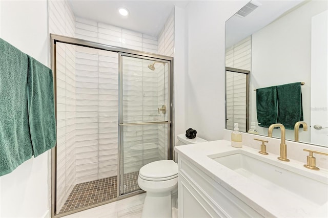 12816 Morning Mist Pl, Venice, FL 34293 - bathroom featuring toilet, vanity, a shower stall, and recessed lighting