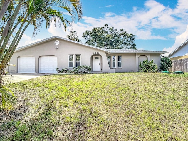 7140 Teaberry St, Englewood, FL 34224 - ranch-style house with stucco siding, an attached garage, and concrete driveway