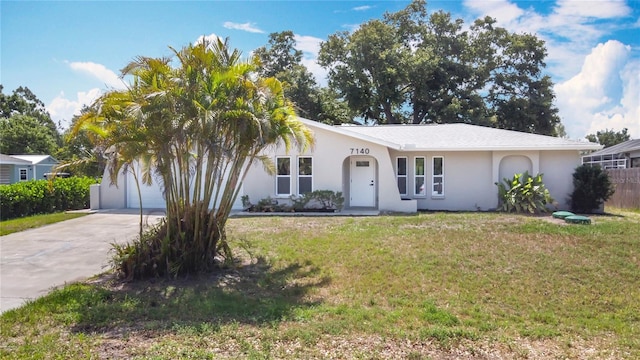 7140 Teaberry St, Englewood, FL 34224 - ranch-style home featuring driveway, a front yard, stucco siding, and an attached garage