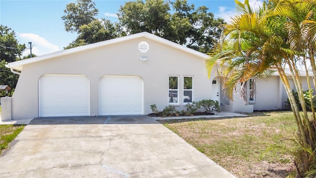 7140 Teaberry St, Englewood, FL 34224 - view of front of house featuring stucco siding, a garage, and driveway