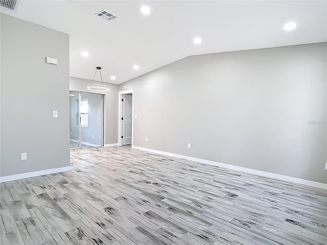 7140 Teaberry St, Englewood, FL 34224 - spare room featuring light wood-style flooring, baseboards, recessed lighting, and vaulted ceiling