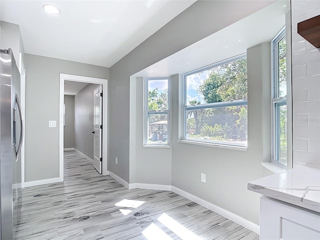 7140 Teaberry St, Englewood, FL 34224 - unfurnished dining area featuring light wood-style floors and baseboards