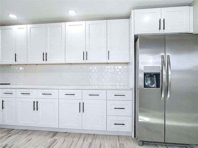 7140 Teaberry St, Englewood, FL 34224 - kitchen with stainless steel refrigerator with ice dispenser, white cabinetry, recessed lighting, and backsplash
