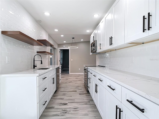 7140 Teaberry St, Englewood, FL 34224 - kitchen featuring open shelves, appliances with stainless steel finishes, tasteful backsplash, a sink, and white cabinets