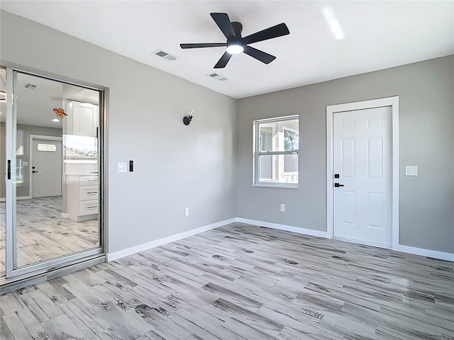 7140 Teaberry St, Englewood, FL 34224 - empty room featuring light wood-type flooring, a ceiling fan, and baseboards