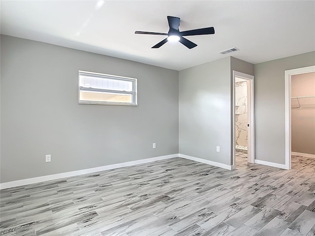 7140 Teaberry St, Englewood, FL 34224 - unfurnished bedroom featuring a spacious closet, wood finished floors, a closet, baseboards, and a ceiling fan