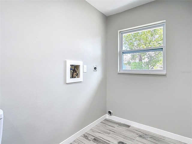 7140 Teaberry St, Englewood, FL 34224 - laundry area with electric dryer hookup, baseboards, hookup for a washing machine, and light wood-style flooring