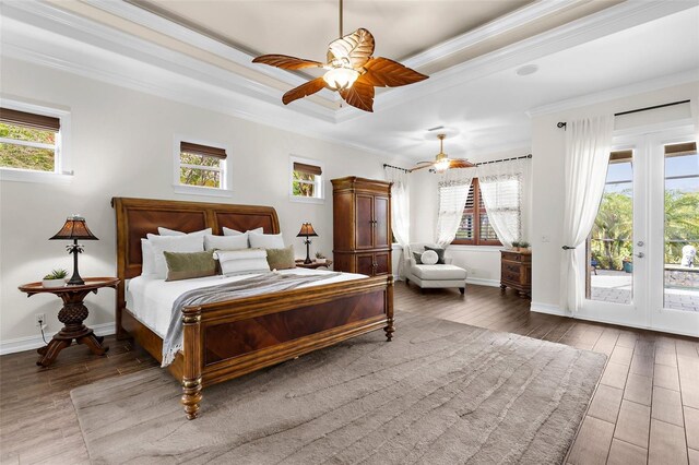 186 Portofino Dr, Nokomis, FL 34275 - bedroom with access to outside, crown molding, multiple windows, wood finished floors, and a tray ceiling