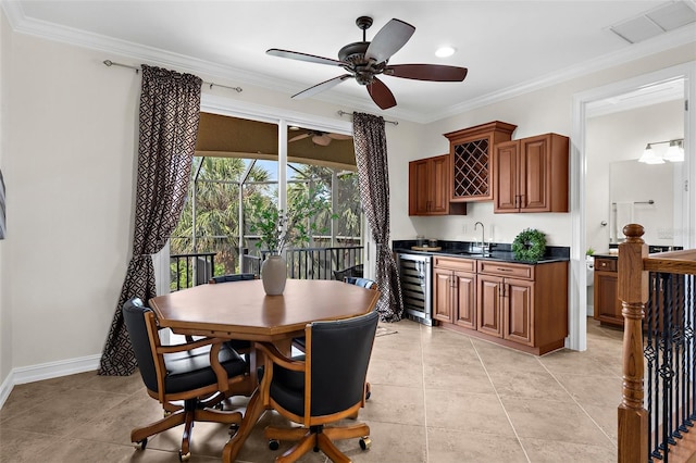 186 Portofino Dr, Nokomis, FL 34275 - dining room featuring wine cooler, wet bar, ornamental molding, ceiling fan, and baseboards