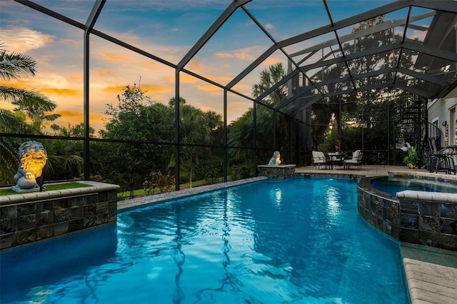 186 Portofino Dr, Nokomis, FL 34275 - pool at dusk featuring a pool with connected hot tub, a lanai, and a patio