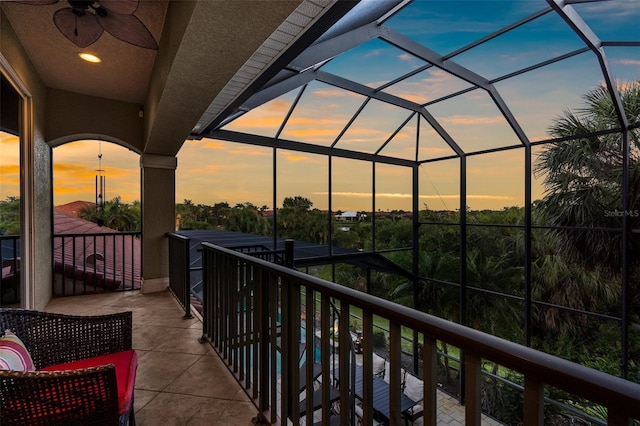 186 Portofino Dr, Nokomis, FL 34275 - balcony at dusk featuring a sunroom and ceiling fan