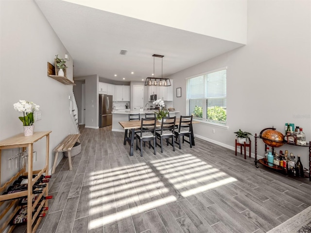 15364 Isla Palma Ln, Nokomis, FL 34275 - dining area featuring light wood-style flooring, baseboards, stairway, and recessed lighting