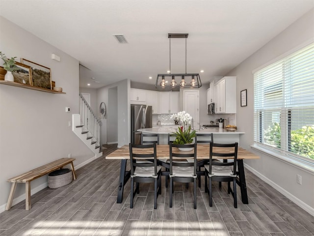 15364 Isla Palma Ln, Nokomis, FL 34275 - dining space with wood finished floors, baseboards, stairs, and recessed lighting