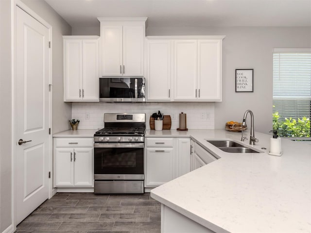 15364 Isla Palma Ln, Nokomis, FL 34275 - kitchen featuring appliances with stainless steel finishes, a sink, white cabinetry, and backsplash