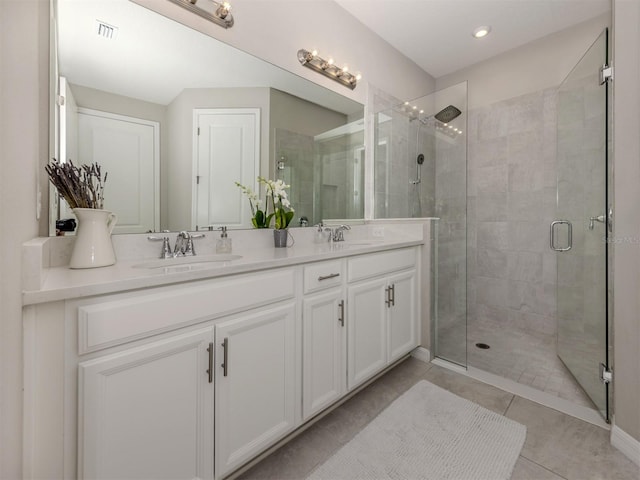 15364 Isla Palma Ln, Nokomis, FL 34275 - bathroom with double vanity, a shower stall, tile patterned flooring, and recessed lighting