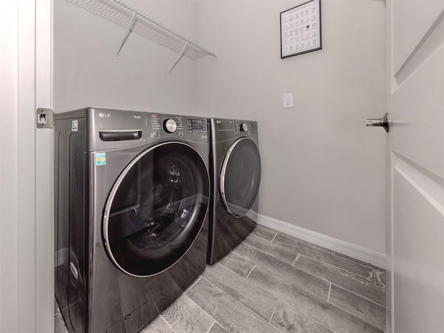 15364 Isla Palma Ln, Nokomis, FL 34275 - laundry room with washer and dryer, baseboards, and wood tiled floors